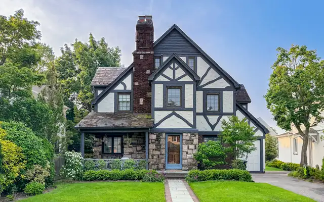 A Tudor-style house behind a green lawn